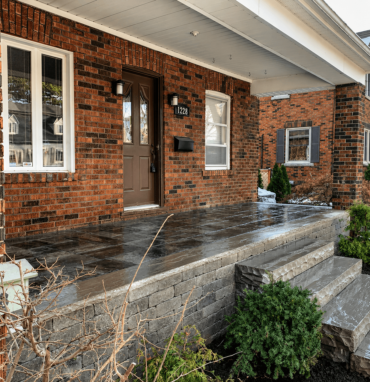 Brick home front porch with pressed concrete patio and decorative block facing